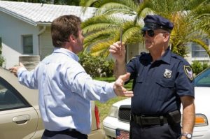 Police officer giving a sobriety test to a drunk driver.